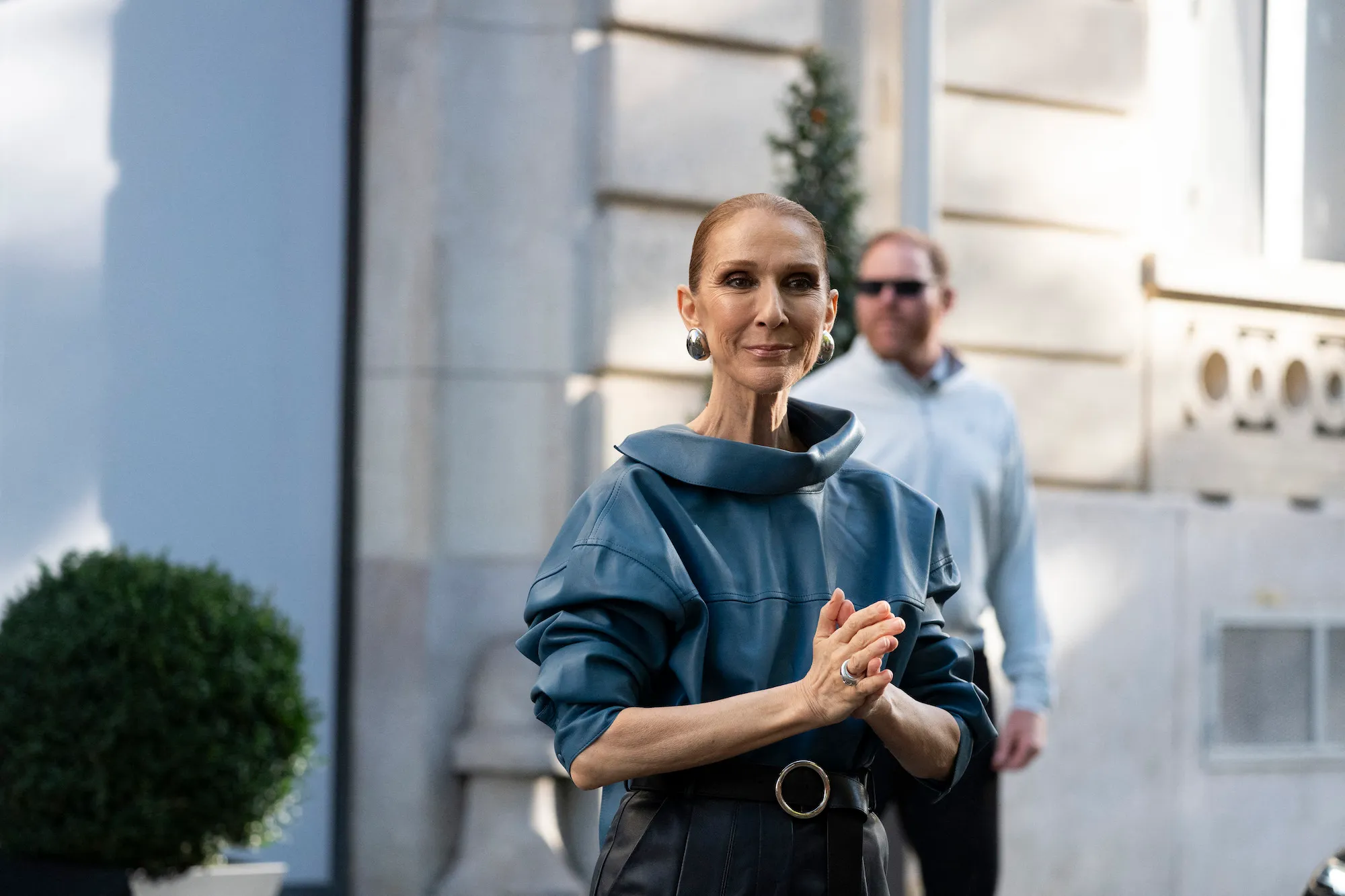 Celine Dion smiling on stage during a concert performance