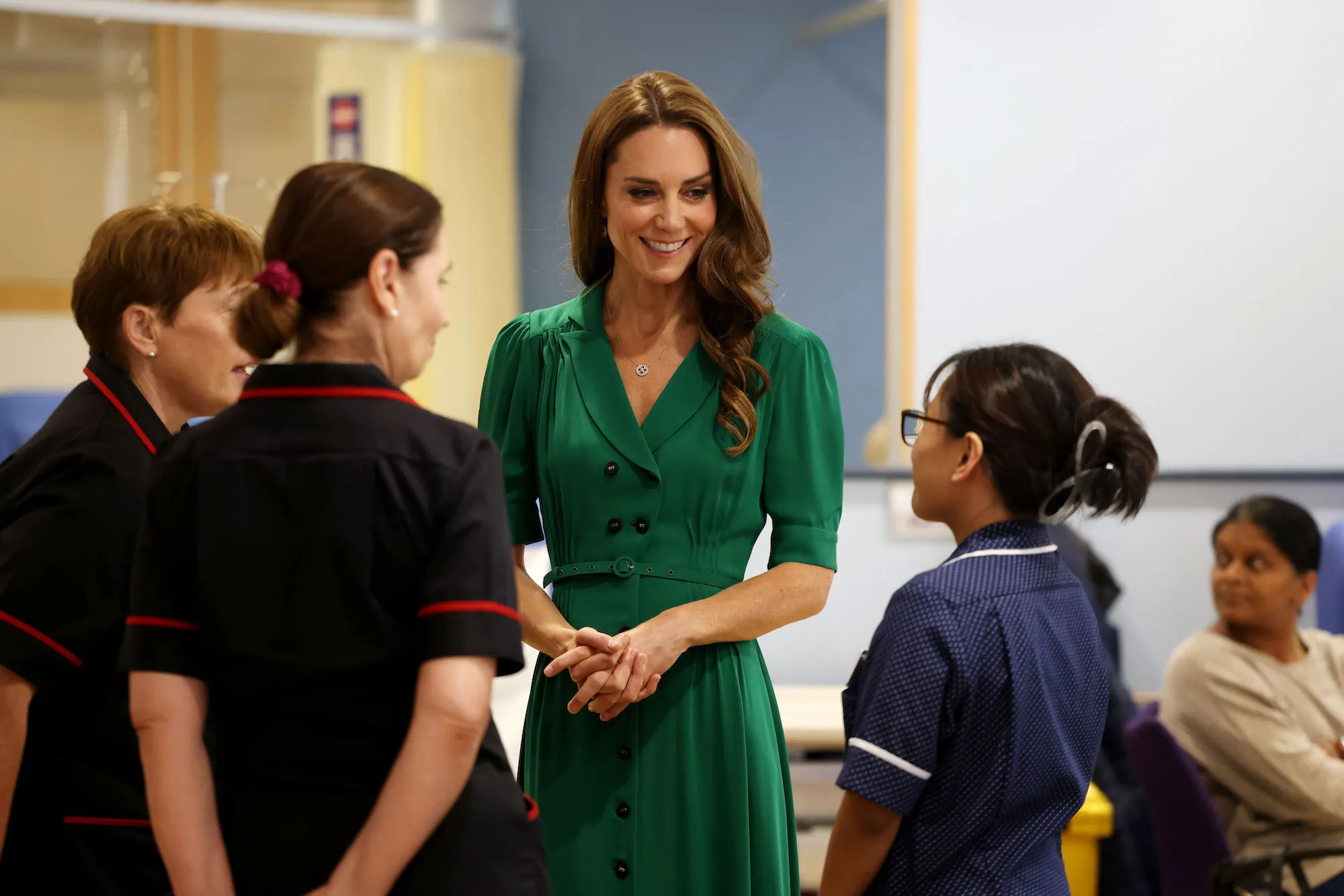 Kate Middleton wearing an emerald dress during a public appearance