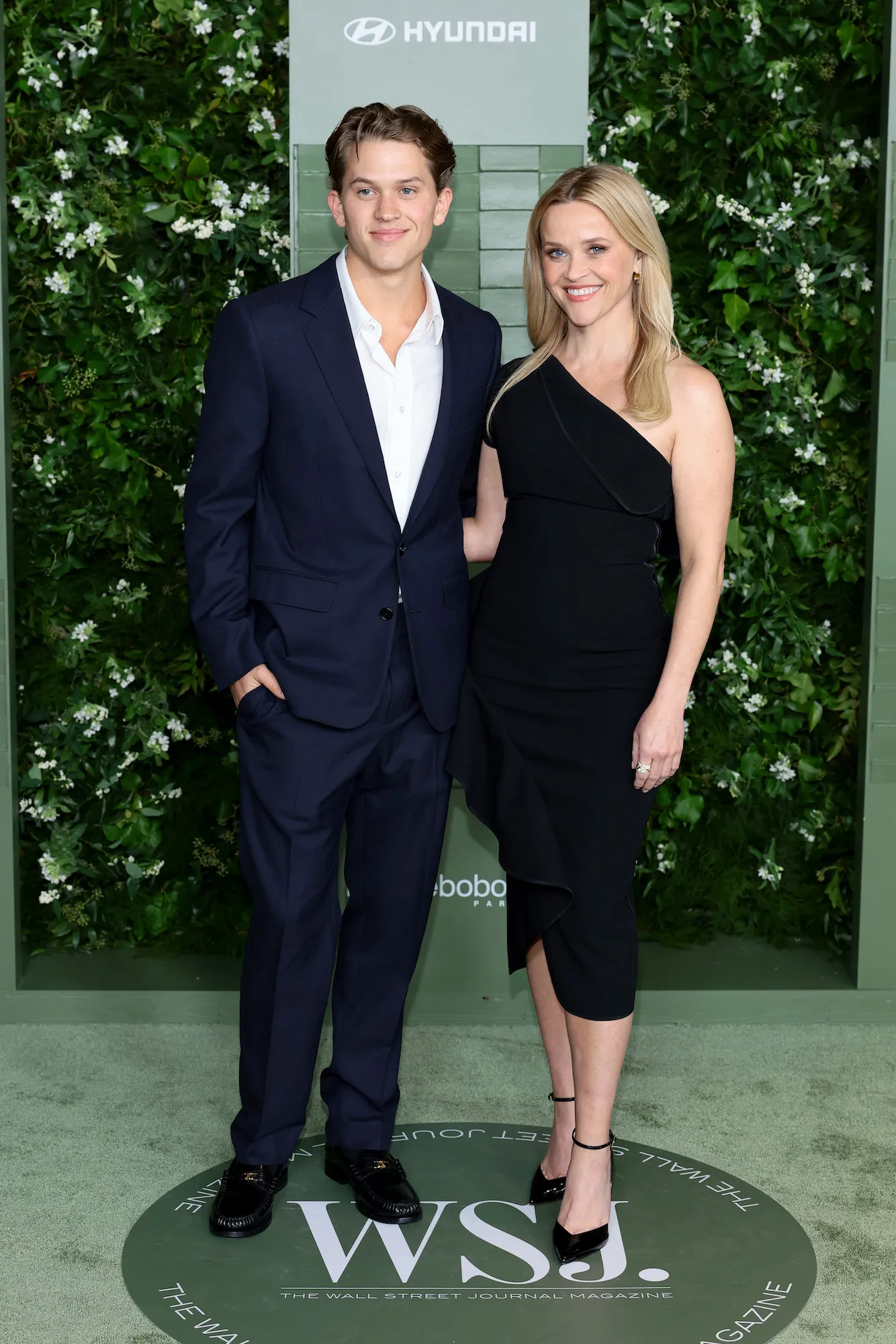 Deacon Phillippe posing on a red carpet at a Hollywood premiere event