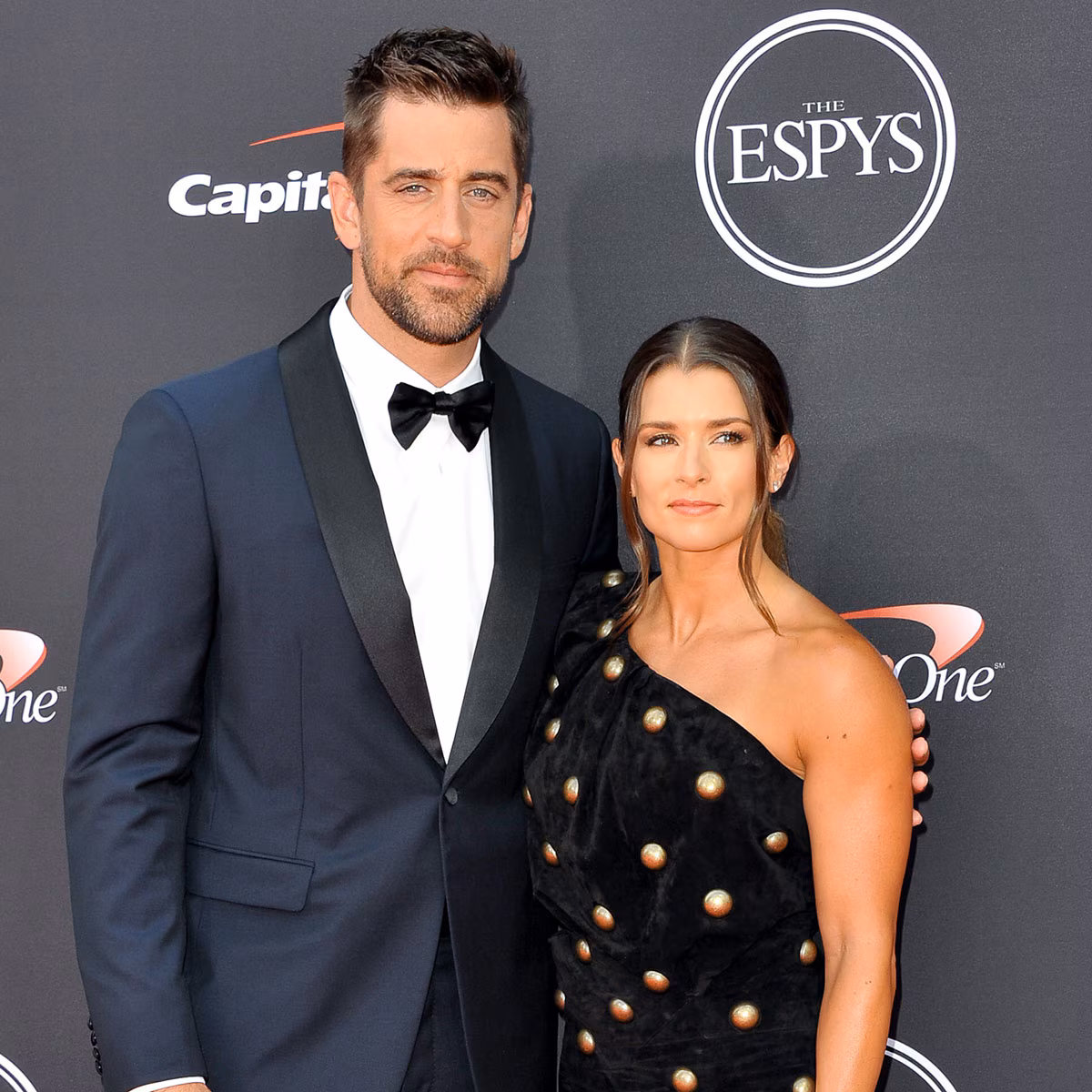 Aaron Rodgers and Danica Patrick posing together at an event