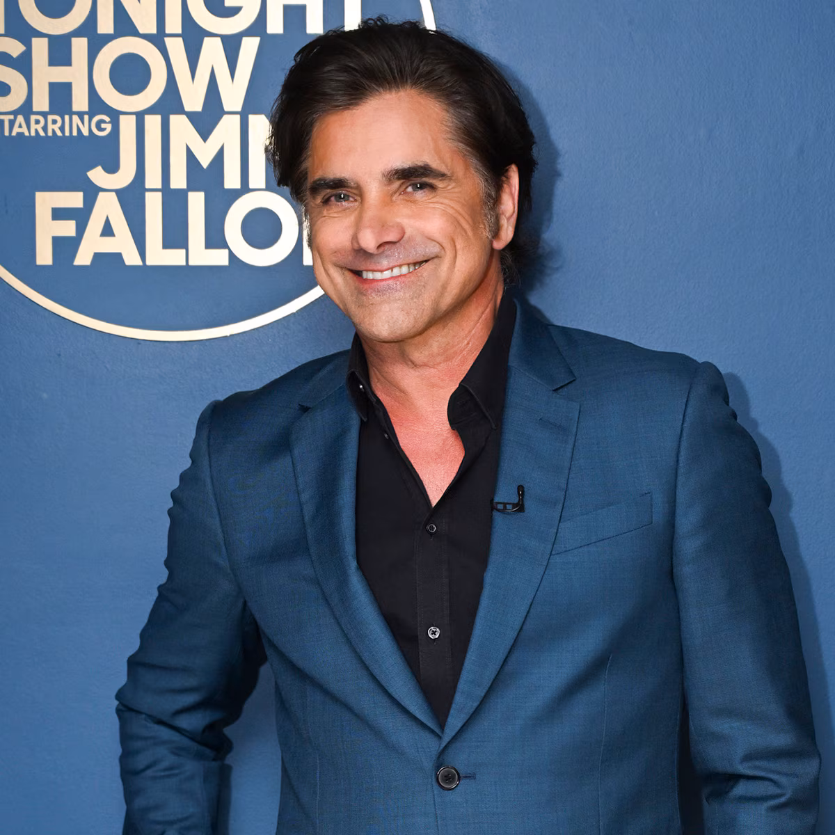 John Stamos posing for a birthday photo snapshot