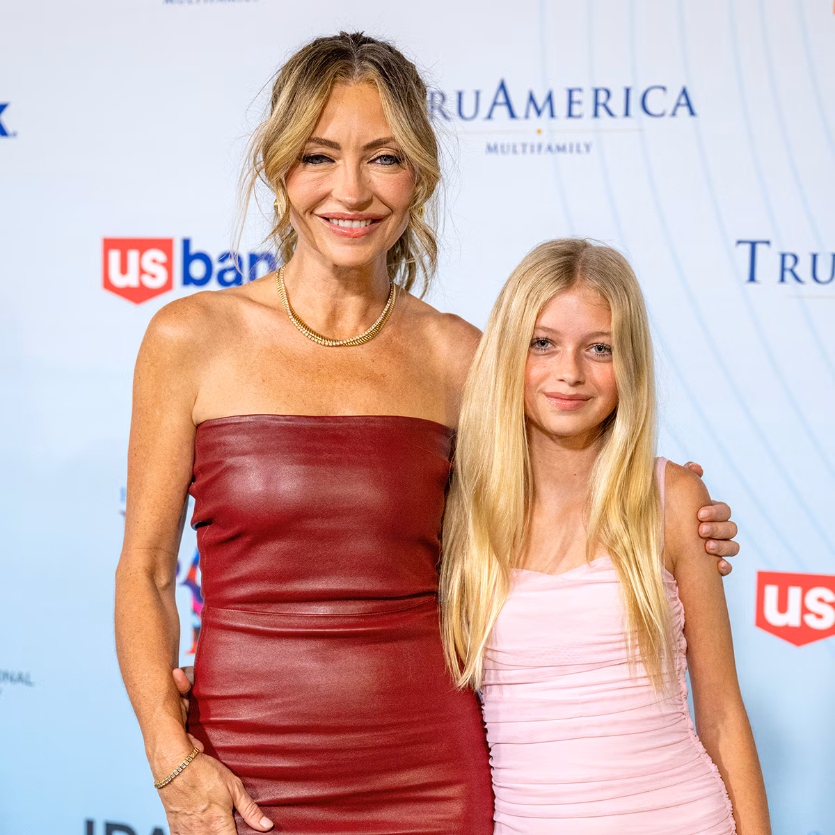 Eric Dane and Rebecca Gayheart posing on a red carpet with daughter Georgia Dane
