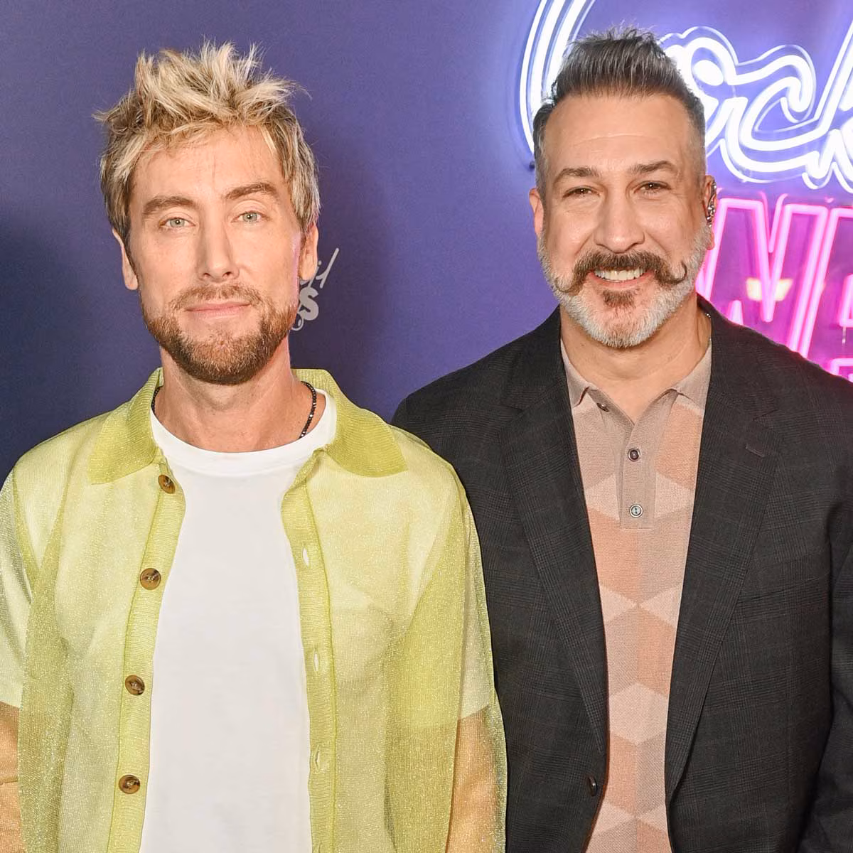 Lance Bass and Joey Fatone pose together at a red carpet event