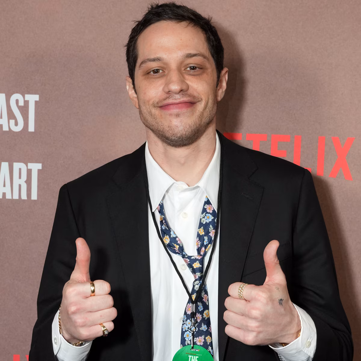 Pete Davidson wearing a long dark wig and blue contact lenses on a movie set