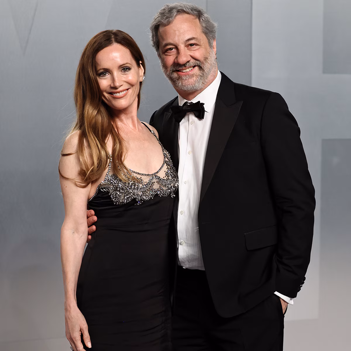 Leslie Mann and Judd Apatow standing together on a Hollywood red carpet