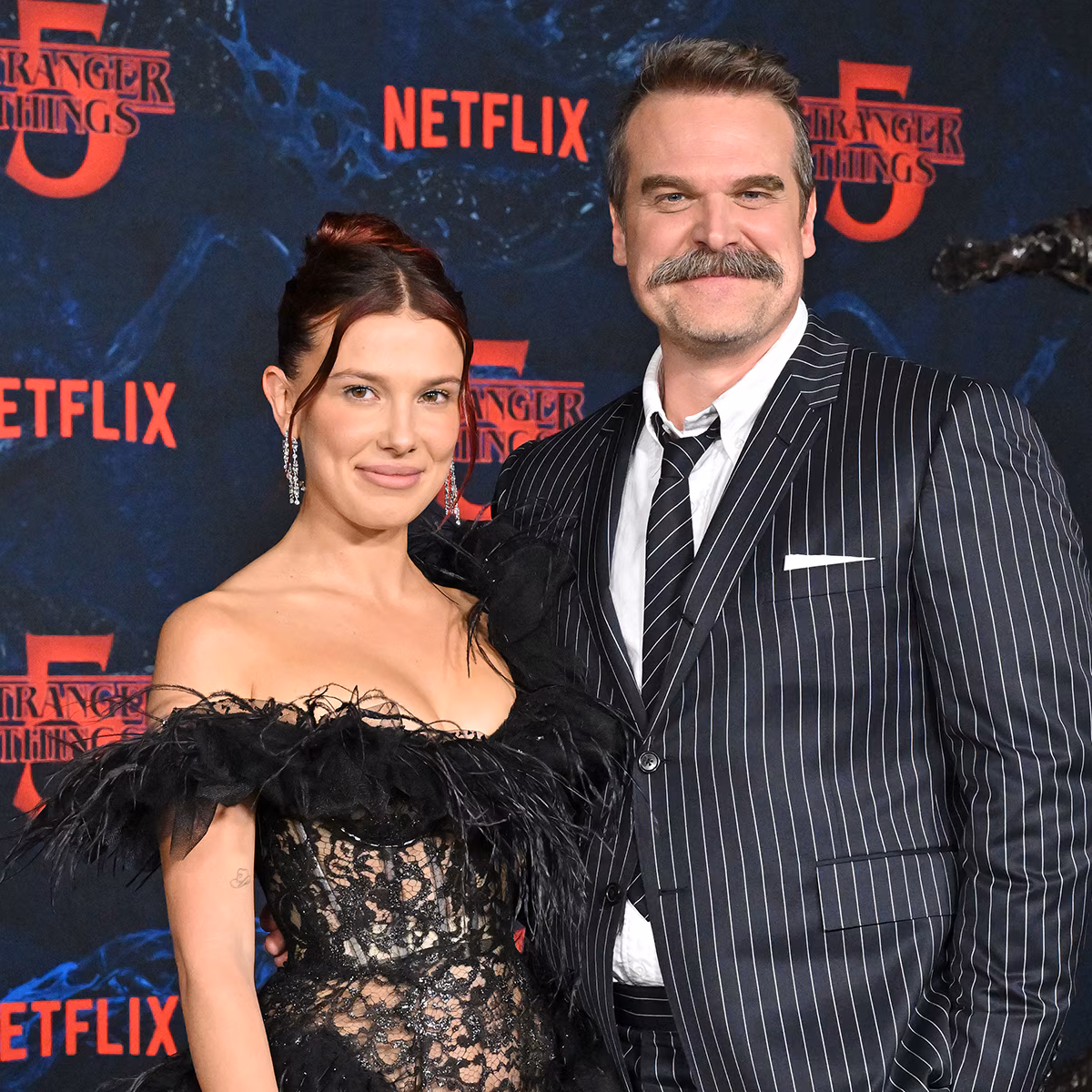 David Harbour and Millie Bobby Brown pose together at an event