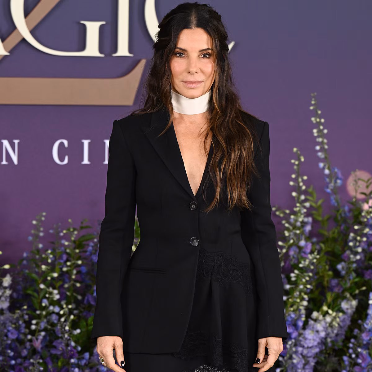 Sandra Bullock smiling on a red carpet at a movie premiere