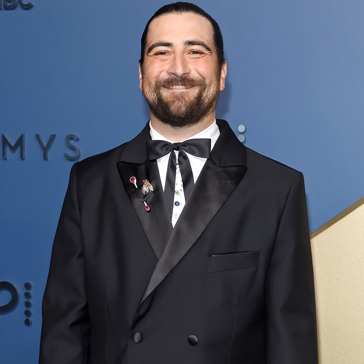 Noah Kahan performing on stage at an awards show