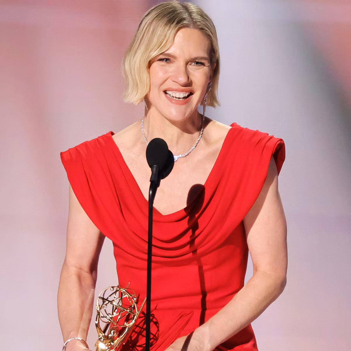 Rhea Seehorn holding an award on stage