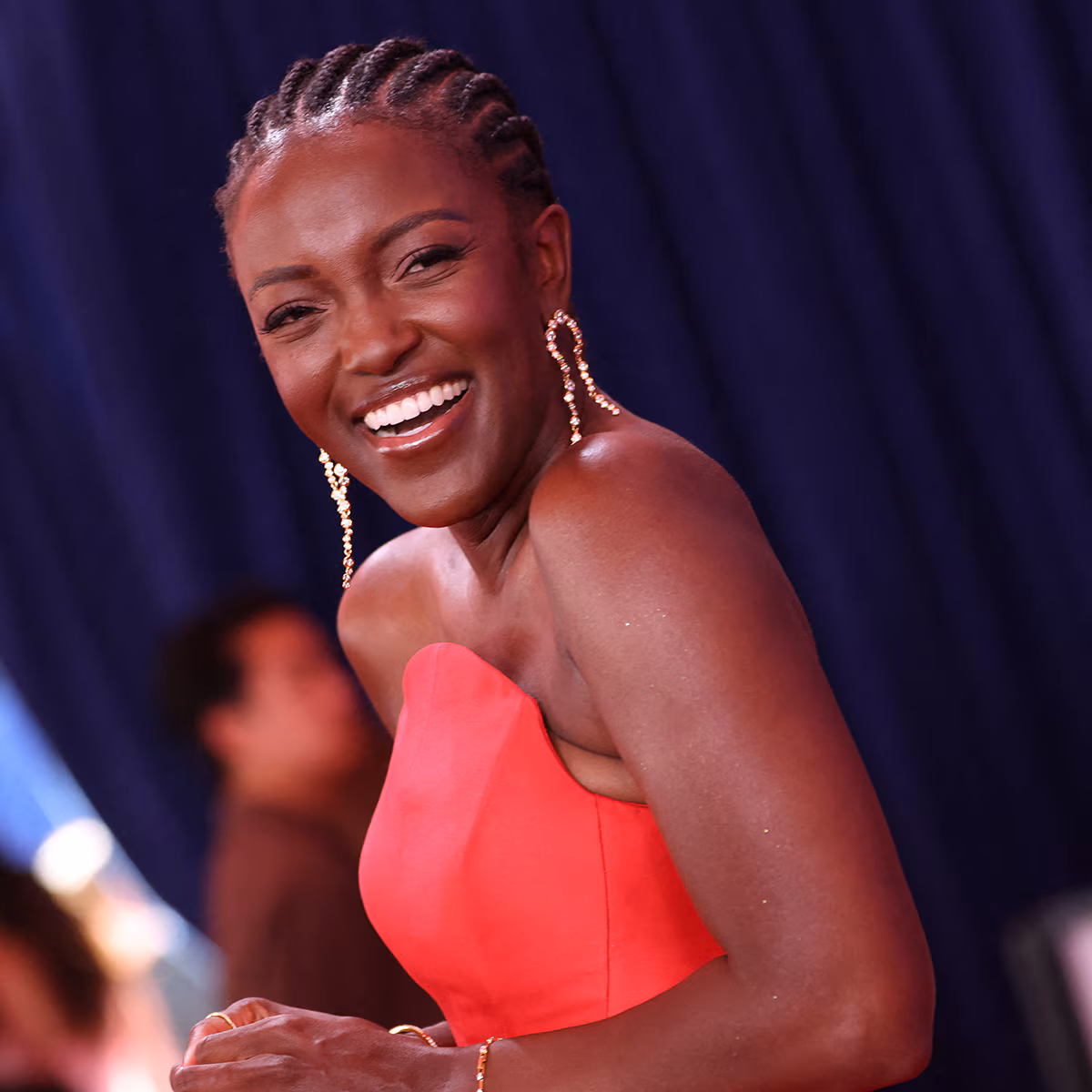 Krys Marshall posing on a red carpet in a glam gown