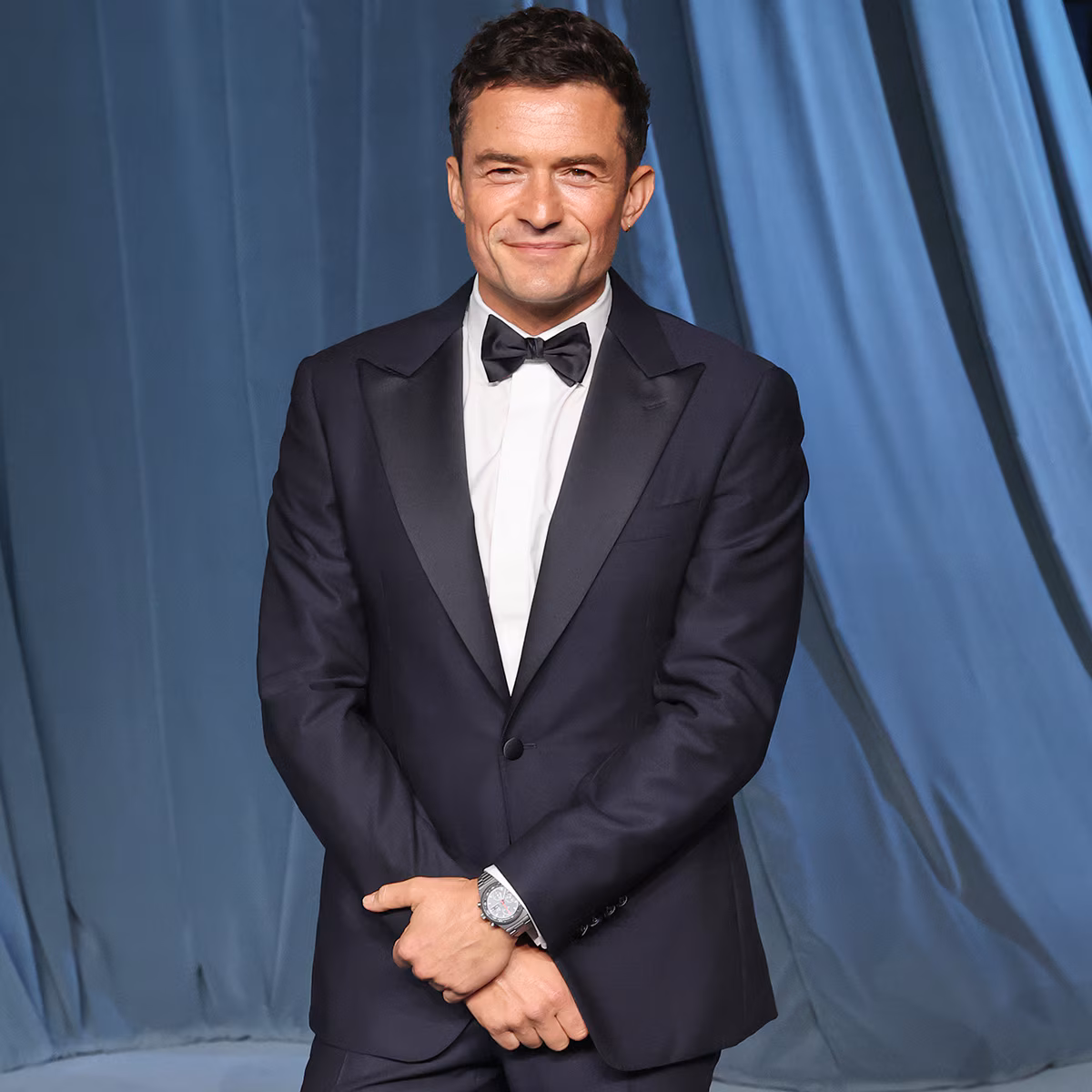Orlando Bloom showing off his ripped abs on a sunny beach vacation
