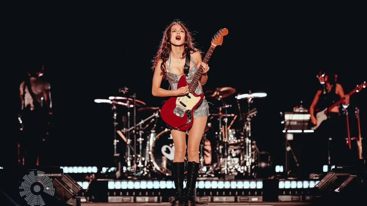 Olivia Rodrigo singing live on stage during a concert