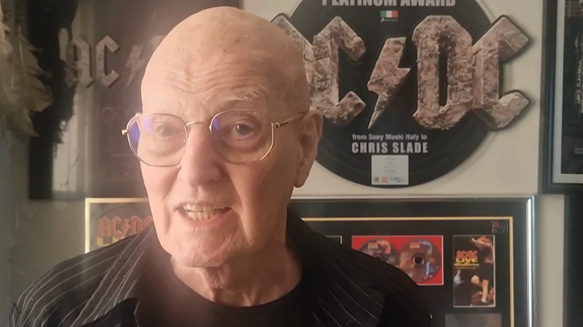Former AC/DC drummer Chris Slade performing on stage behind his drum set