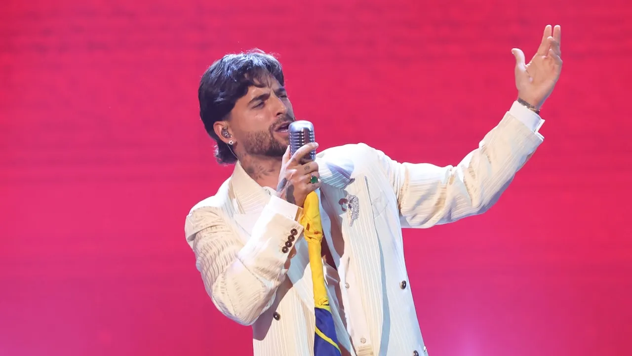 Maluma performing live on stage in front of thousands of fans