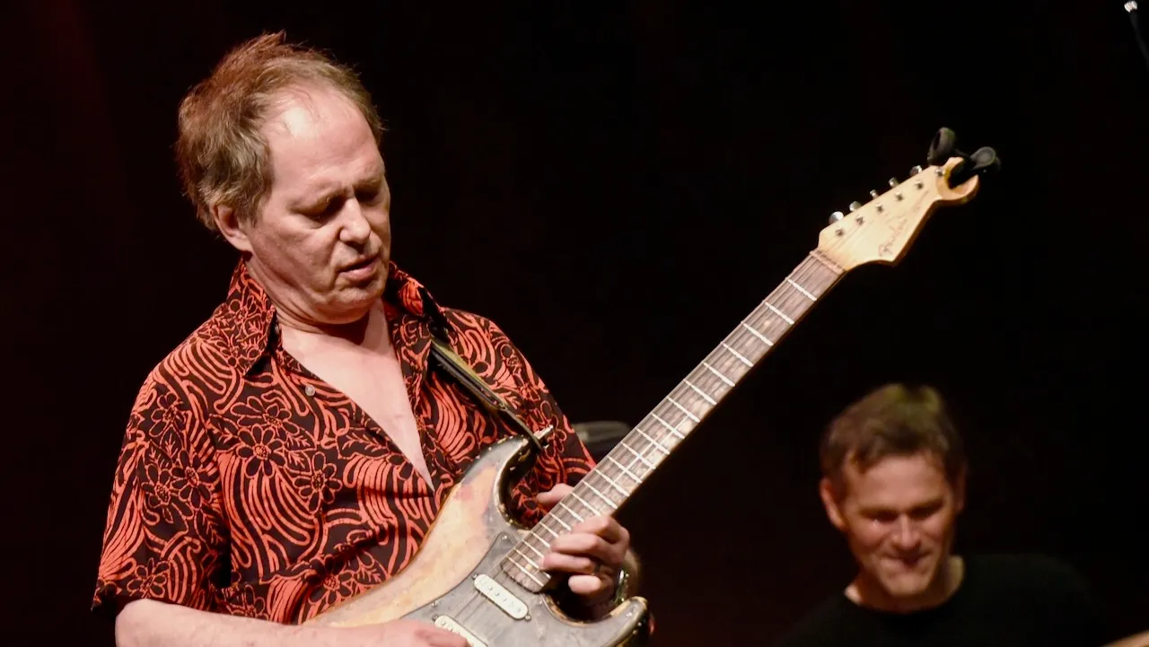 Richard Lloyd performing live with his guitar