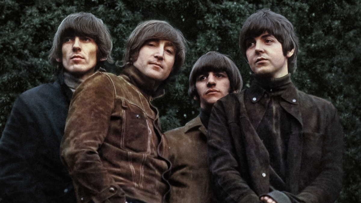The Beatles performing together during a 1960s studio session.