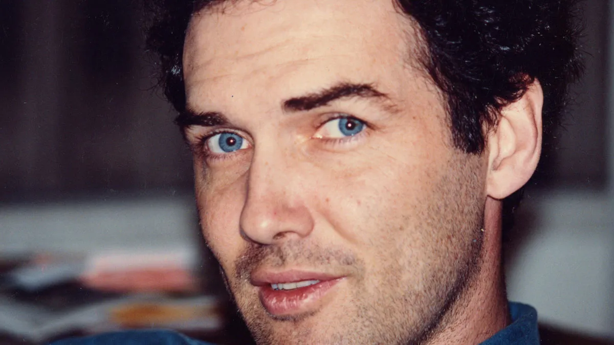 Norm Macdonald smiling during a comedy appearance