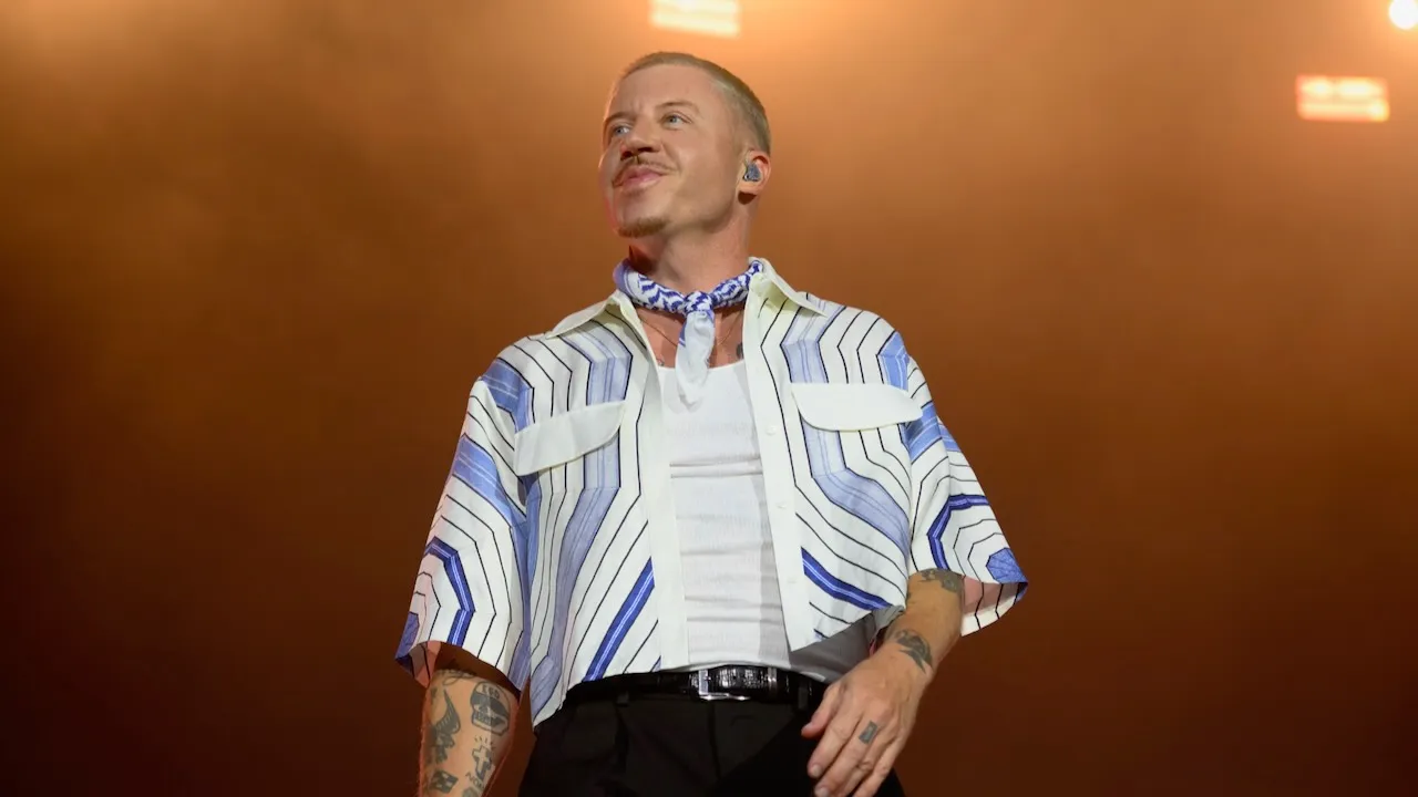 Macklemore performing live on stage during a concert tour