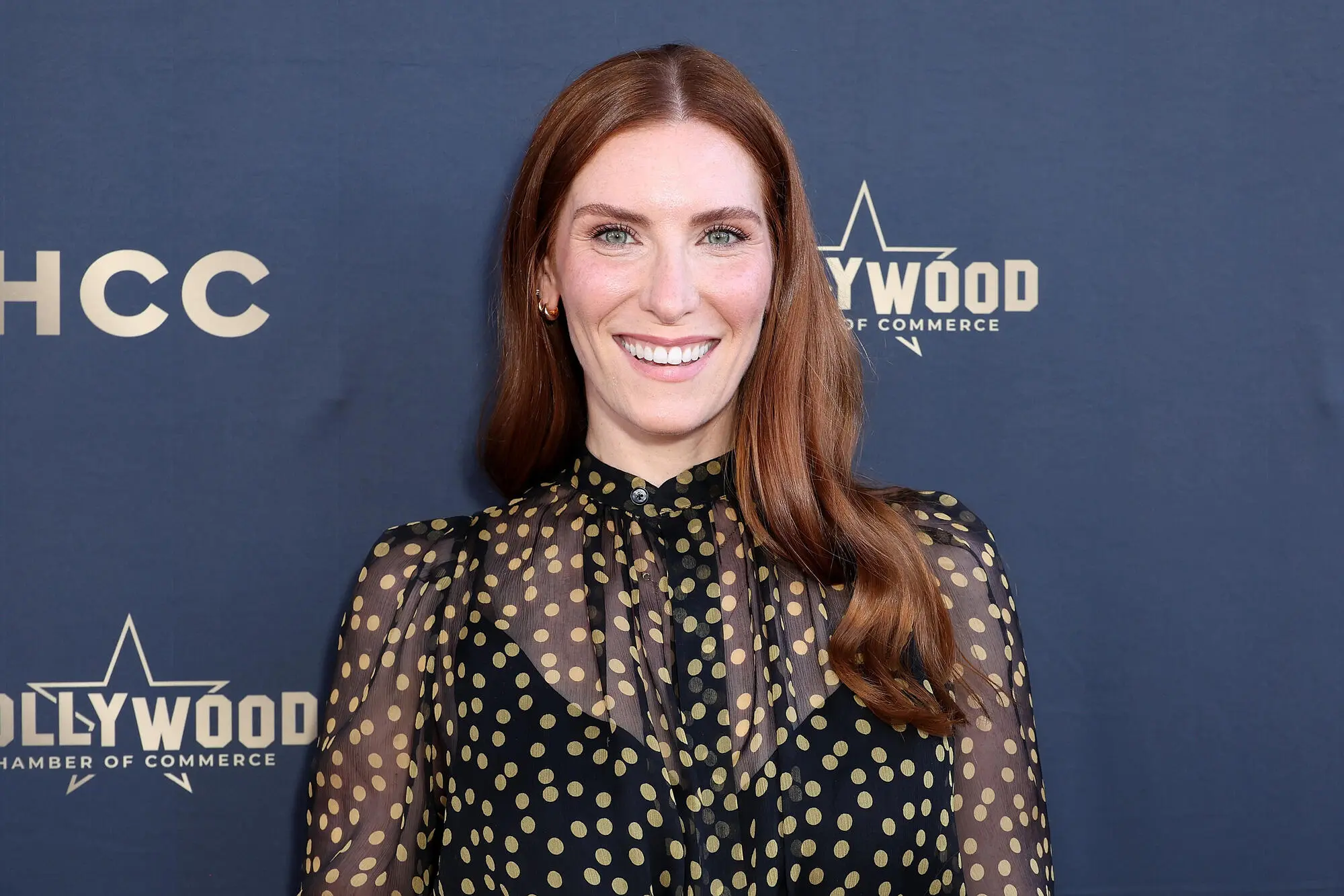 Sarah Levy posing at a Hollywood red carpet event