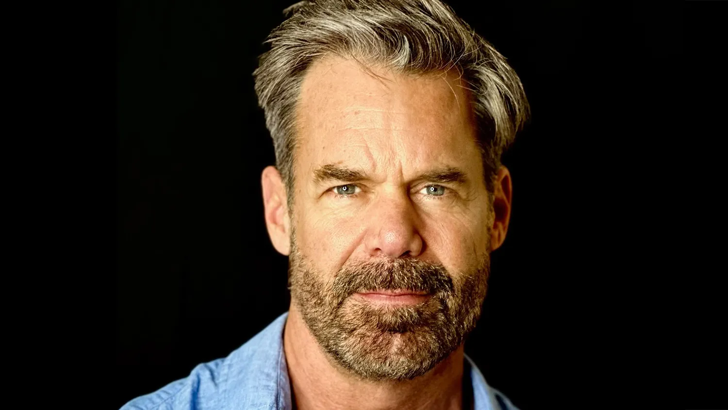 Tuc Watkins smiling on a red carpet event