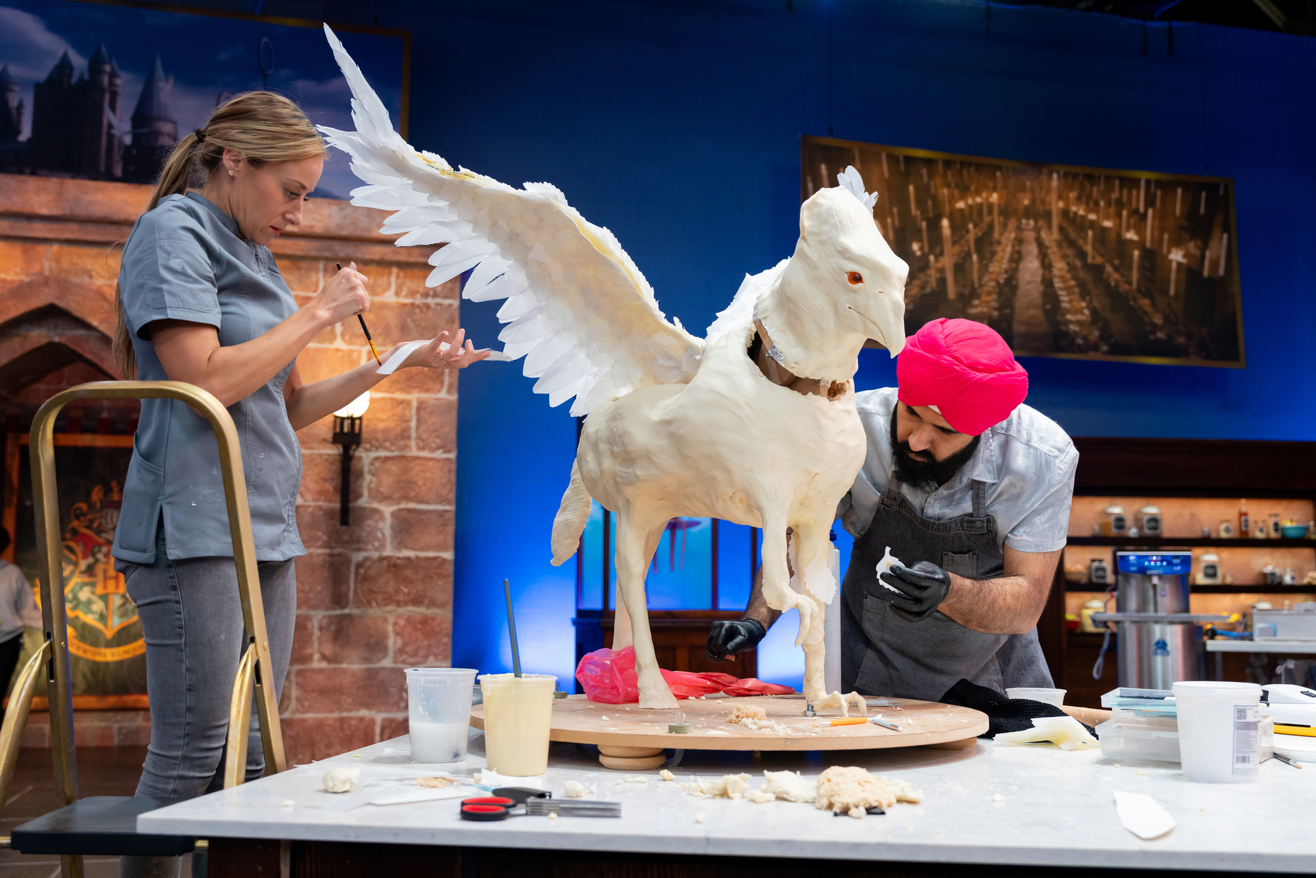 A elaborate fantasy-themed cake displayed on a cooking competition stage.