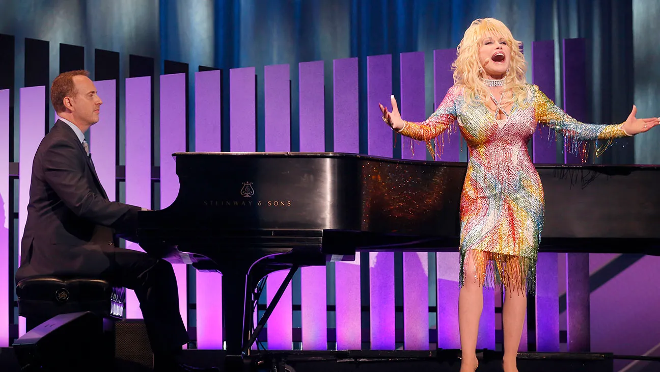 Robert Greenblatt and Dolly Parton performing together on stage