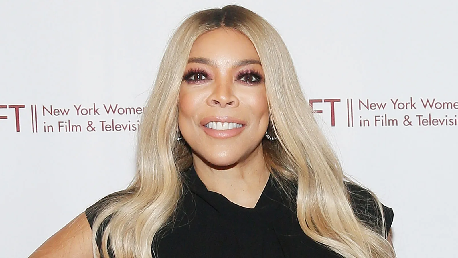Wendy Williams smiling on set during a television recording