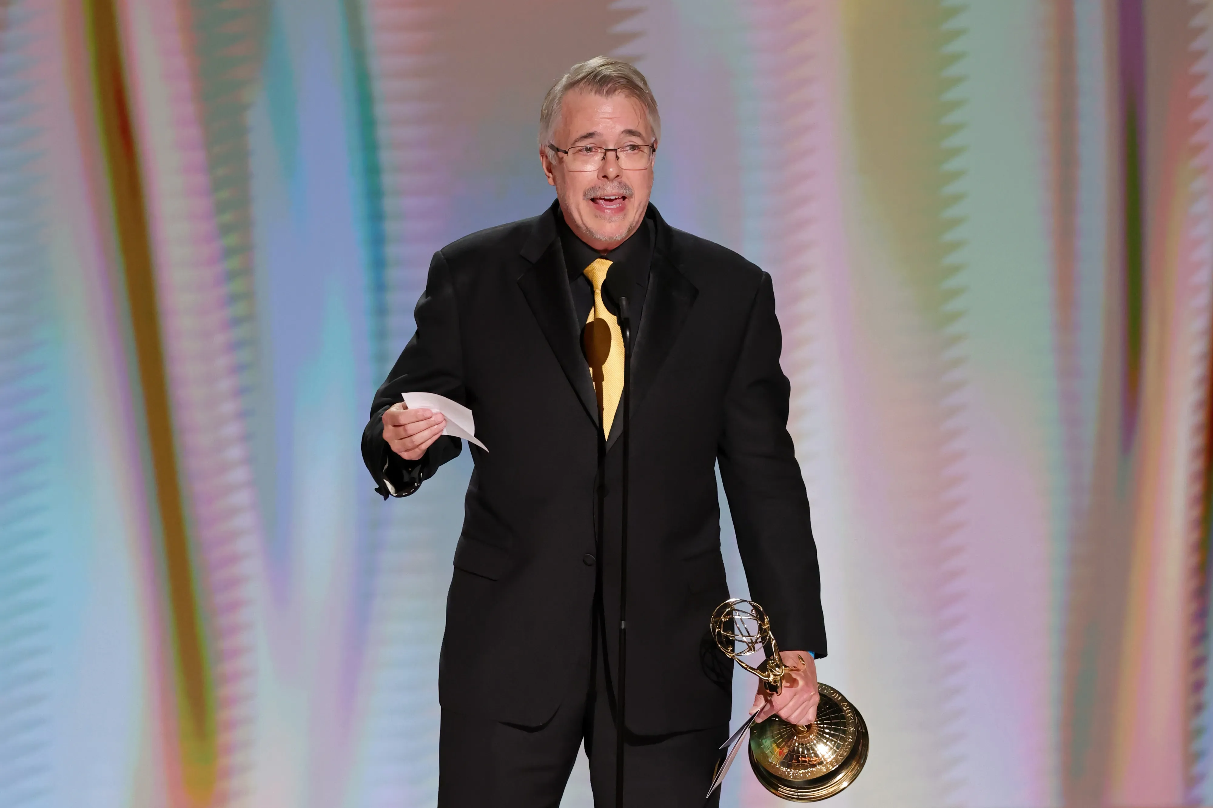 Vince Gilligan holding an Emmy Award on stage