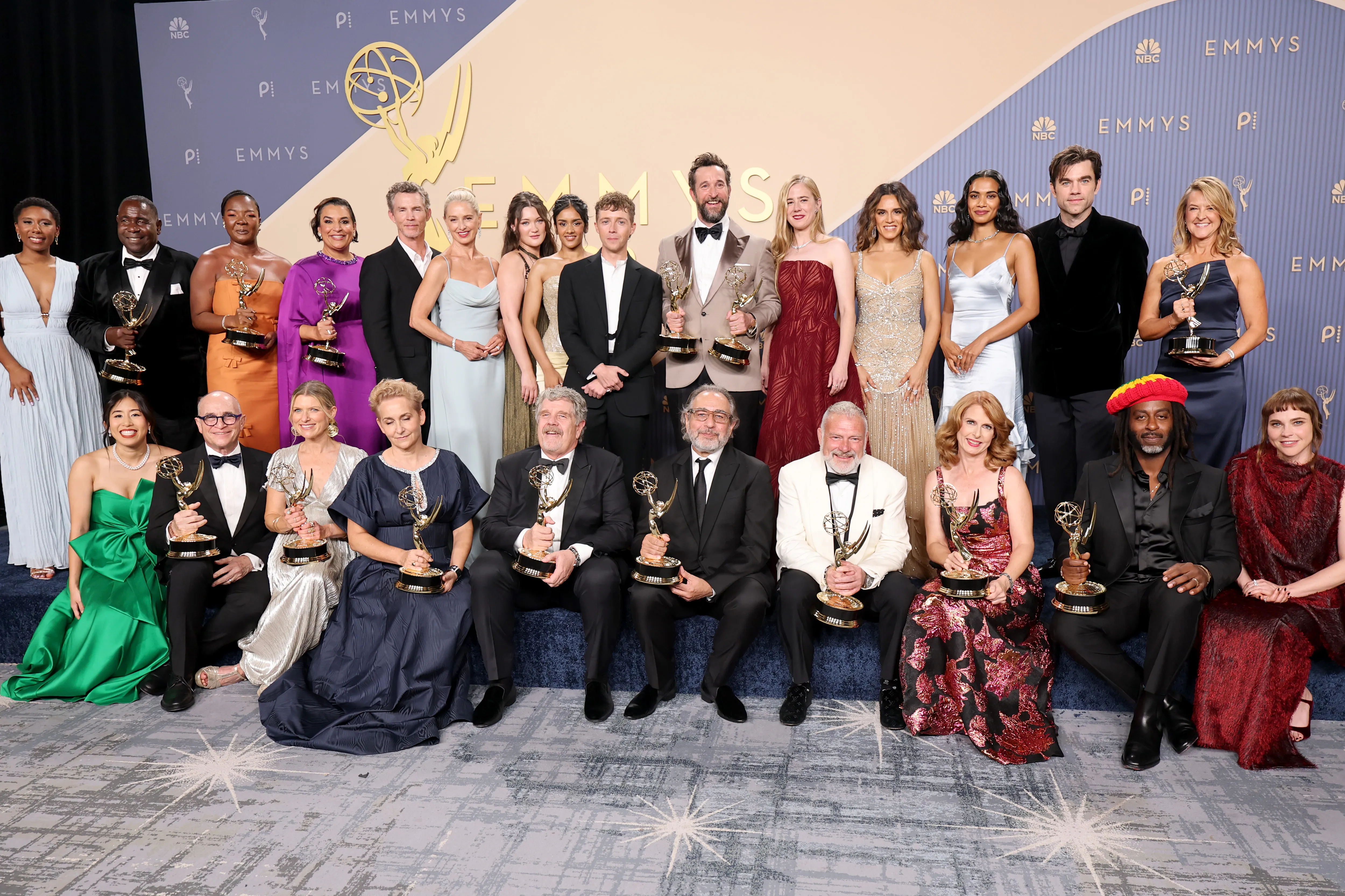 Noah Wyle holding an Emmy Award backstage at the annual ceremony