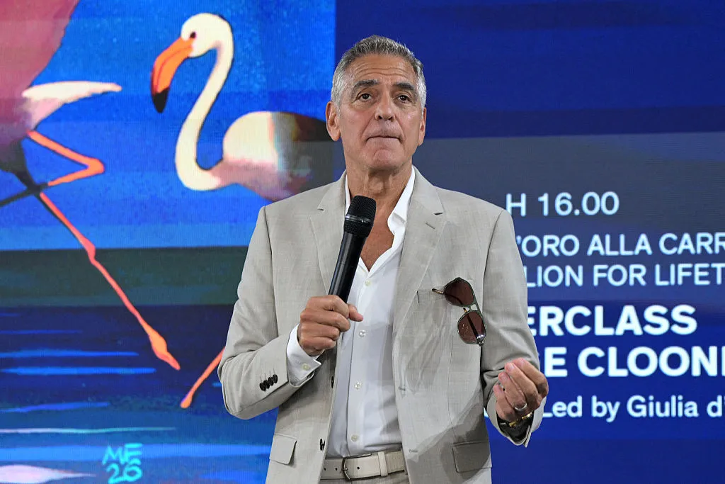 George Clooney speaking on stage at a film festival masterclass