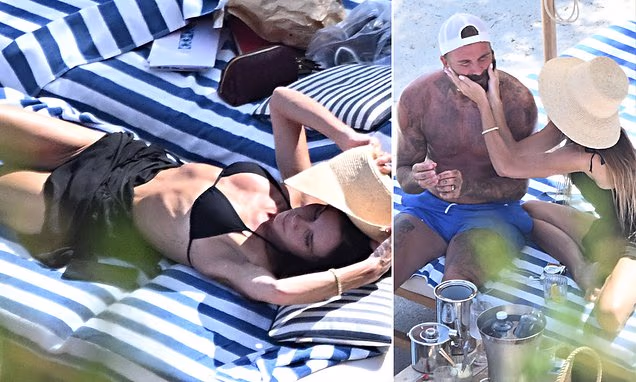 Victoria Beckham wears a black triangle bikini next to shirtless husband David Beckham in Portofino, Italy.