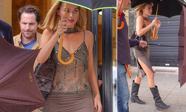 Margot Robbie wearing a sheer top and thigh-split skirt during a night out in Paris with husband Tom Ackerley.