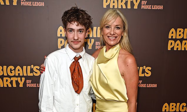 Tamzin Outhwaite smiling on the red carpet at her West End press night with son Flo Ellis-Outhwaite