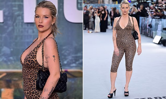 Lottie Moss posing on the red carpet at the London premiere of The Dog Stars wearing a leopard print unitard
