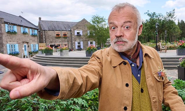 Graham Norton smiling on stage at a television industry event