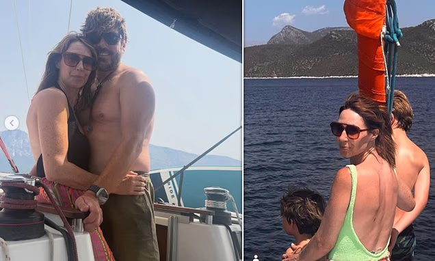 Alex Jones hugging her shirtless husband Charlie Thomson on a boat