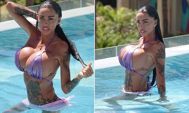 Katie Price wearing a purple bikini during a swim on holiday in Marbella, Spain.