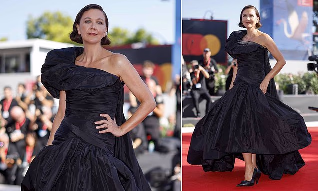 Maggie Gyllenhaal posing in a dramatic black gown on the Venice Film Festival red carpet