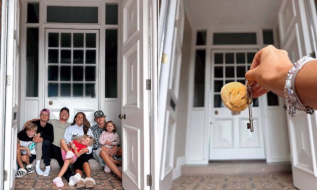 Stacey Solomon and Joe Swash posing outside their new family house
