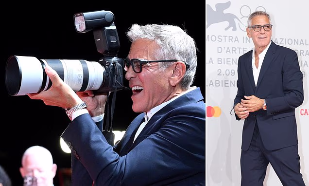 George Clooney smiling and posing at a major film festival red carpet