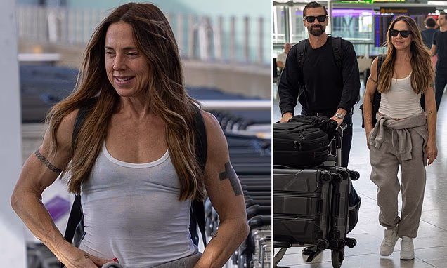 Mel C walking through London Heathrow Airport displaying her toned arms