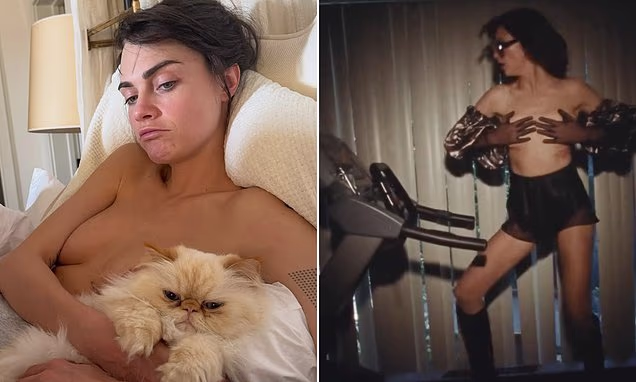 Cara Delevingne posing in bed with her pet cat
