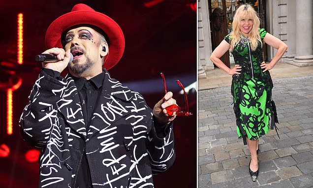 Boy George wearing a bold hat and colorful outfit at a red carpet event
