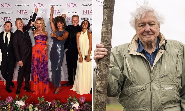 Sir David Attenborough smiling on a red carpet