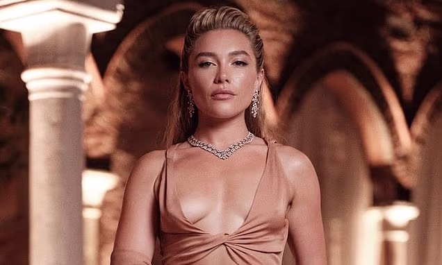 Florence Pugh posing in a plunging crop top and dramatic skirt at a Max Mara event in Venice
