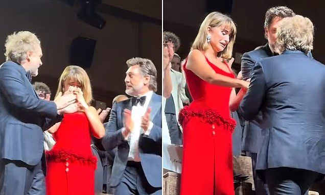 Penelope Cruz crying during a standing ovation alongside Javier Bardem