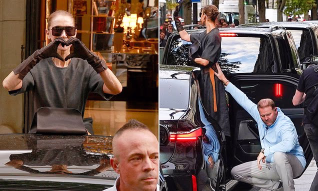 Celine Dion waving to fans from her vehicle in high heels while a team member assists her