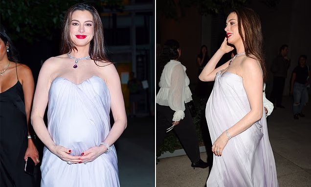 Anne Hathaway showing her baby bump in a strapless lilac dress at a Bvlgari event in New York City.