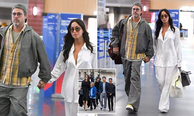Brad Pitt and Ines de Ramon holding hands at JFK Airport