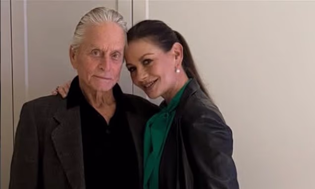 Catherine Zeta-Jones and Michael Douglas posing together at a red carpet movie premiere.